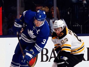 Toronto's Dion Phaneuf, left, gets hooked by Boston's Brad Marchand during in Game 6 of the Eastern Conference quarter-finals May 12, 2013 at the Air Canada Centre in Toronto, Ontario, Canada. (Photo by Abelimages/Getty Images)