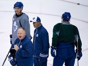 Maple Leafs head coach Randy Carlyle, left, instructs his players at practice in Toronto on Tuesday, May 7, 2013. THE CANADIAN PRESS/Nathan Denette
