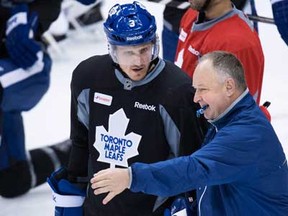 Maple Leafs head coach Randy Carlyle, right, speaks to captain Dion Phaneuf at practice in Toronto on Tuesday, May 7, 2013. THE CANADIAN PRESS/Nathan Denette