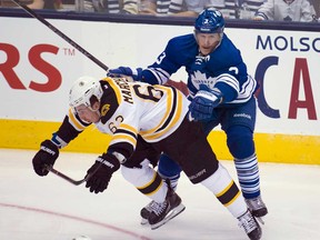 Toronto Maple Leafs defenceman Dion Phaneuf, right, hits Boston Bruins forward Brad Marchand, left, during first period NHL hockey playoff action in Toronto Monday, May 6, 2013. (THE CANADIAN PRESS/Nathan Denette)