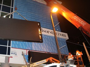 MARCH 22, 2013: A crane operator lifts one of four large horizontal sections of the Windsor Star LED display board. (DAN JANISSE / The Windsor Star)