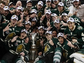 The London Knights pose with the OHL championship trophy after beating the Barrie Colts on May 13, 2013. (Dave Chidley / Canadian Press)