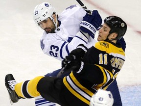 Leafs defenceman Ryan O'Byrne, top, checks Boston's center Gregory Campbell during Game 5 of the first-round playoff series in Boston Friday, May 10, 2013. (AP Photo/Charles Krupa)