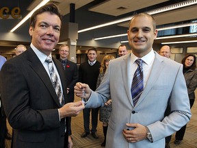 Nov. 1, 2012: David Mady hands over the keys to the new offices of The Windsor Star to editor-in-chief Marty Beneteau in the former Palace Theatre. (TYLER BROWNBRIDGE / The Windsor Star)