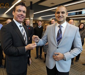 Nov. 1, 2012: David Mady hands over the keys to the new offices of The Windsor Star to editor-in-chief Marty Beneteau in the former Palace Theatre. (TYLER BROWNBRIDGE / The Windsor Star)