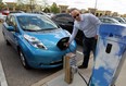 Sean Hart charges his new Nissan Leaf electric car at a charging station at the Windsor Crossing Outlet. (TYLER BROWNBRIDGE/The Windsor Star)