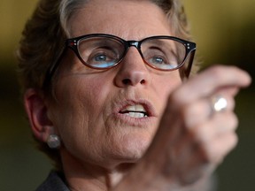 Ontario Premier Kathleen Wynne answers reporters questions at a news conference at the University of Ottawa's Social Sciences Building in Ottawa, Monday, May 13, 2013. THE CANADIAN PRESS/Sean Kilpatrick