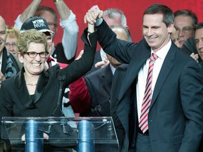 New Ontario Premier Kathleen Wynne is congratulated by outgoing Premier Dalton McGuinty after winning the leadership race at the Ontario Liberal Party leaderhip convention in Toronto on Saturday January 26, 2013. (THE CANADIAN PRESS/Frank Gunn)