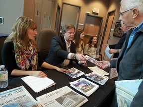 Cartoonist Mike Graston signs copies of his cartoon during an open house at the new Windsor Star building in Windsor on Saturday, May 11, 2013.                            (TYLER BROWNBRIDGE/The Windsor Star)