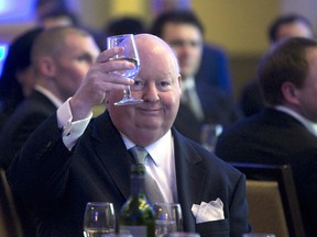 Senator Mike Duffy holds up his glass during the Maritime Energy Association's annual dinner in Halifax on Feb. 6, 2013. THE CANADIAN PRESS/Devaan Ingraham
