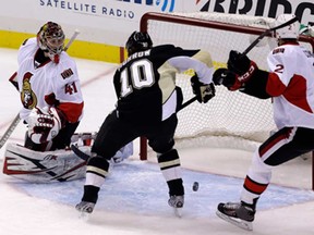 Pittsburgh's Brenden Morrow, centre, beats Ottawa's Jared Cowen, right, to the puck behind Senators goalie Craig Anderson  for a goal in Game 5 of the Eastern Conference semifinal Friday, May 24, 2013, in Pittsburgh.(AP Photo/Gene J. Puskar)