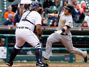 Pittsburgh's Russell Martin, right, comes in to score against Detroit catcher Brayan Pena on a double by Gaby Sanchez during interleague play at Comerica Park May 27, 2013 in Detroit. The Tigers beat the Pirates 6-5. (Duane Burleson/Getty Images)