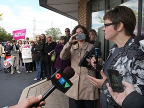 CUPE members protest Friday, May 24, 2013, outside of the office of MPP Teresa Piruzza's constituency office in Windsor, Ont. Piruzza (R) speaks to the demonstrators.(DAN JANISSE/The Windsor Star)