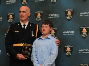 Windsor Police Chief Al Frederick, left, presents a Windsor Police citizen award to Jaden Shaw during the Windsor Police Awards dinner at the St. Clair Centre for the Arts on May 14, 2013 in Windsor, Ontario.   Shaw was recognized for his roll in assisting a stabbing victim and providing information to police that lead to the arrest of the suspect.  (JASON KRYK/ The Windsor Star)