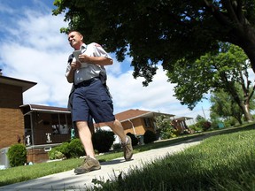 Alan Benoit walks the sidewalks near his regular postal route in Windsor on Friday, May 24, 2013. Dog bites on postal carriers were up last year.                       (TYLER BROWNBRIDGE/The Windsor Star)