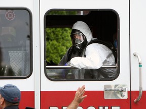 Firefighters dressed in hazardous materials suits prepare to check a man in the 200 Block of McEwan Avenue in Windsor on Wednesday, May 22, 2013. The man claimed he drank a radioactive liquid. Firefighters check the man and were able to determine he had not.                        (TYLER BROWNBRIDGE/The Windsor Star)