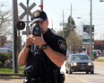 Const. Mark Umbenhower with the Canadian Pacific Police uses a Lidar Speed unit on McDougall Avenue in Windsor, Ontario on May 1, 2013.   (JASON KRYK/The Windsor Star)