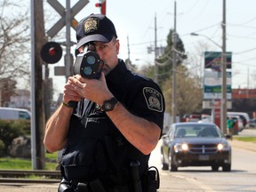 Const. Mark Umbenhower with the Canadian Pacific Police uses a Lidar Speed unit on McDougall Avenue in Windsor, Ontario on May 1, 2013.   (JASON KRYK/The Windsor Star)