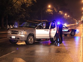 Windsor Police investigate a single-vehicle rollover in the 3200 block of Dougall Avenue in Windsor, Ontario just before midnight on May 27, 2013.   The lone passenger of the pickup truck was removed by Windsor firefighters and EMS paramedics and transported to hospital.   Windsor Police are investigating. (JASON KRYK/The Windsor Star)