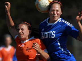 L'Essor's Julia Beqaj, left, and St. Anne's Alana Gyemi battle for the ball during WECSSAA girls soccer action in Tecumseh Wednesday, May 1, 2013. (TYLER BROWNBRIDGE/The Windsor Star)
