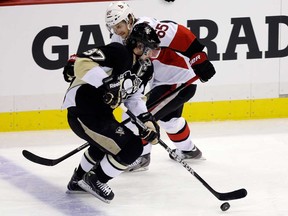 Pittsburgh's Sidney Crosby, front, gets past Ottawa's Erik Karlsson en route to a goal in Game 2 of the NHL Eastern Conference semifinal in Pittsburgh Friday, May 17, 2013. (AP Photo/Gene J. Puskar)