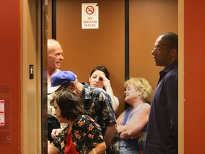 Tenants and visitors to the Cencourse Apartments in downtown Windsor, Ont. crowd into an elevator in the building, Thursday, May 9, 2013. The strike by the international union of elevator constructors has impacted service to the second lift which is out of service. (DAN JANISSE/The Windsor Star)