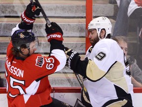 Ottawa's Erik Karlsson, left, collides with Pittsburgh's Pascal Dupuis during Game 4 of the Eastern Conference semifinal in Ottawa Wednesday May 22, 2013. (THE CANADIAN PRESS/Adrian Wyld)