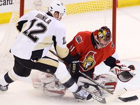 Senators goalie Craig Anderson, right, controls the rebound while Pittsburgh's Jarome Iginla crashes the net during Game 4 of the NHL Eastern Conference semifinal in Ottawa Wednesday May 22, 2013. (THE CANADIAN PRESS/Adrian Wyld)