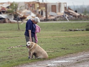 Kay Taylor stands with her dog Bailey in front of her house that was destroyed after the tornado that hit the area near 149th and Drexel on Monday, May 20, 2013 in Oklahoma City, Okla. (AP Photo/ The Oklahoman, Chris Landsberger)