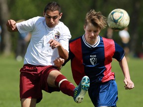 Catholic Central's Anjel Khalid Alias, left, kicks the ball in front of Cardinal Carter's Evan Nash at the Teutonia Club in Windsor Monday, May 6, 2013. (TYLER BROWNBRIDGE/The Windsor Star)