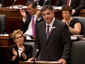 Ontario premier Kathleen Wynne, left, claps as Minister of Finance Charles Sousa delivers the provincial budget on behalf of Ontario's minority Liberals at Queens Park in Toronto, Ontario, May 2, 2013.   (Tyler Anderson/National Post)