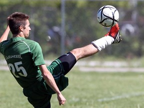 Stefan Boulineau of Lajeunesse kicks the ball away from Forster players in the WECSSAA boys A soccer final at Forster May 24, 2013.  (NICK BRANCACCIO/The Windsor Star)