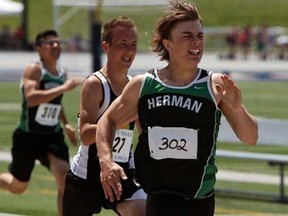 Herman's Brett Banwell, right, runs to victory in his 200-metre heat during the WECSSAA track and field championships at Alumni Field in Windsor Wednesday, May 15, 2013. (TYLER BROWNBRIDGE/The Windsor Star)
