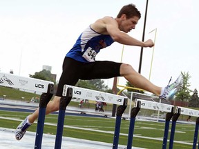 Nathan Hesman competes in hurdles during the SWOSSAA track and field competition at Alumni Field in Windsor Thursday, May 23, 2013. (TYLER BROWNBRIDGE/The Windsor Star)