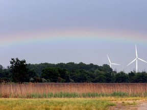 In this file photo, a rainbow forms beyond wind turbines during spring rain shower in Kingsville, Ontario on May 28, 2013.  (JASON KRYK/ The Windsor Star)