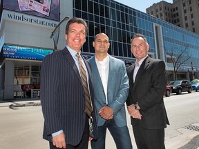 Marty Beneteau, editor-in-chief of The Windsor Star, left, David Mady, president of Mady Development Corporation, and Marty Komsa, CEO of Windsor Family Credit Union, stand at the corner of University and Ouellette avenues on May 1, 2013. The WFCU plans to open  a branch at 300 Ouellette Ave., the building shown in the background. (DAN JANISSE/The Windsor Star)