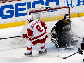 Detroit's Justin Abdelkader, left, scores on Anaheim's Jonas Hiller during the first period in Game 7 in Anaheim, Calif., Sunday, May 12, 2013. (AP Photo/Chris Carlson)