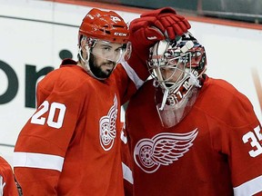 Detroit's Drew Miller, left, congratulates goalie Jimmy Howard (35) after beating the Chicago Blackhawks 3-1 in Game 3 of the Western Conference semifinal game in Detroit Monday, May 20, 2013. (AP Photo/Paul Sancya)