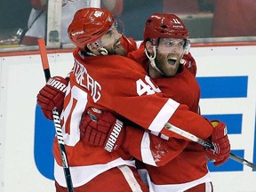 Detroit's Daniel Cleary, right, celebrates his empty-net goal against the Blackhawks with teammate Henrik Zetterberg during the third period of Game 4 of the Western Conference semifinal in Detroit, Thursday, May 23, 2013. Detroit won 2-0. (AP Photo/Paul Sancya)