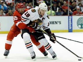 Detroit defenceman Niklas Kronwall, left, battles Chicago's Jonathan Toews during Game 4 of the Western Conference semifinal in Detroit, Thursday, May 23, 2013. (AP Photo/Paul Sancya)