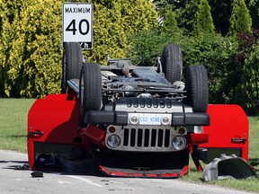 LaSalle firefighters, shown, LaSalle Police and Essex-Windsor EMS paramedics at the scene of a two-vehicle collision at Maple and Michigan avenues where a 2012 Jeep Wrangler ended up on its roof Tuesday May 4, 2013.  The driver of the Jeep and another driver of a Dodge Grand Caravan were taken to hospital with non-lifethreatening injuried.  (NICK BRANCACCIO/The Windsor Star)