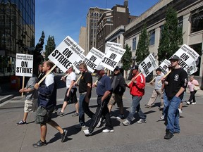 Striking members of International Union of Elevator Constructors walk to different workplaces around downtown Windsor Tuesday June 4, 2013.  The strike ended Friday, June 28, 2013, when an agreement was reached late in the day.  (NICK BRANCACCIO/The Windsor Star)