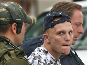 Aug. 28, 2006: Shane Huard, age 25, arrested in a police takedown at the corner of Meltcalf Street and Henry Ford Centre is led to a prisoner transport wagon following a high risk takedown  by Windsor Police Emergency Services Unit officers.   Huard has been charged with 1st degree. (Windsor Star files)