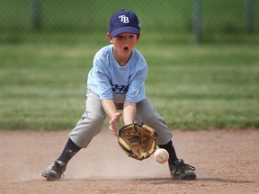 Shortstop Miles Walsh, 8, fields the ball while competing in a house league match during the 2nd Annual 100-inning game at Riverside Baseball Park, Saturday, June 22, 2013.  (DAX MELMER/The Windsor Star)