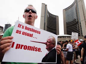 A protester joins the crowd at Nathan Phillips Square in front of Toronto city hall calling for Toronto Mayor Rob Ford to step down on Saturday, June 1, 2013. (CANADIAN PRESS files)