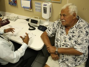 Dr. K. Rasool consults with Tamas Molnar, 72, at the Men's Health Clinic at the Sandwith Community Health Centre, Saturday, June 15, 2013.  (DAX MELMER/The Windsor Star)