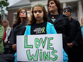 Cecilia Floros, 10, of Newtown attends a remembrance event on the six-month anniversary of the massacre at Sandy Hook Elementary School on June 14, 2013 in Newtown, Conn. A a 26-second moment of silence was observed to honor the 20 children and six adults who were killed at the school on Dec. 14. The event also included the reading of the names of over 6,000 people who have been killed by gun violence since the massacre in Newtown. (Photo by Spencer Platt/Getty Images)