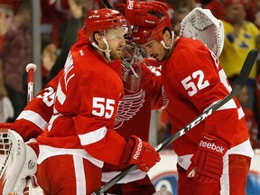 Detroit's Niklas Kronwall, from left, goalie Jimmy Howard and defenceman Jonathan Eriksson celebrate a goal against the Blackawks. Shamus/Getty Images) ORG XMIT)
