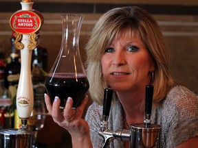 Sandy Limoges of Sandy's Riverside Grill has Amarone-style red wine on tap at the popular Riverside bar and grill, June 2013. The wine taps are located directly beside the draft beer taps.  (NICK BRANCACCIO/The Windsor Star)