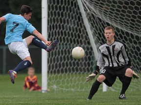 Windsor's Ardit Dushkaj, left, kicks the ball towards Michigan Bucks goalie Nate Steinwasher during their exhibition game Tuesday at Windsor Stadium. (DAN JANISSE/The Windsor Star)